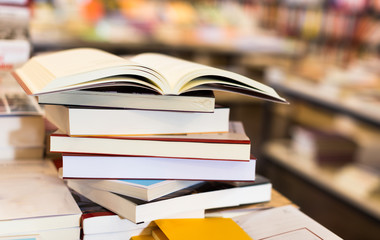 stack of books lying on table in bookstore