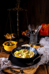 Reginette noodles in cream sauce with fresh chanterelles and capers