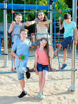 Five  kids posing  at the playground together