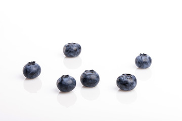 many blue berry on the wood table, whitebackground.