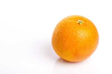 orange on the wood table, grey background.