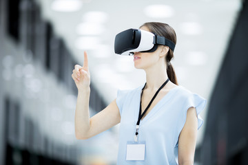 Young modern participant of virtual conference touching display while making presentation