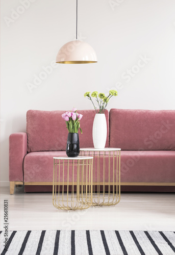Golden Small Tables With Flowers Pink Couch And Chandelier In A Golden Small Tables With Flowers Pink Couch And Chandelier In A Living Room Interior