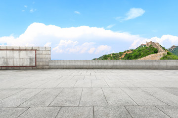 Empty square floor and great wall with mountains