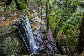 looking down on waterfall as it cascades into creek below