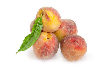 Fresh peaches with leaf on a white background