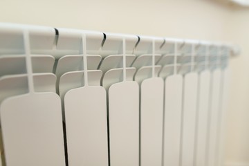Close-up of white radiator heater in apartment.