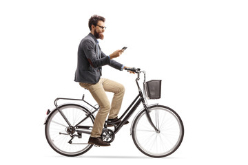 Fototapeta na wymiar Young man riding a bicycle and looking at his phone