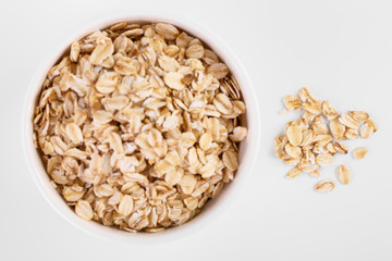 pile of oatmeal isolated on white background. Creative layout made of organic oatmeal isolated on white background. Food concept.