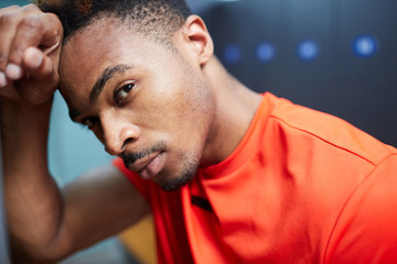 Young footballer of African-american origin thinking of last game of football that was really hard © pressmaster