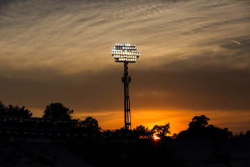 Stadium lights on sunset background
