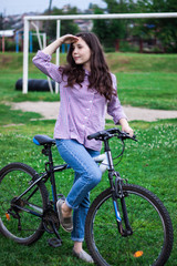 Bikes cycling girl. Girl rides bicycle out city.