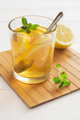 Glass of lemon tea with mint
