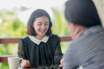 Asian girls playing domino game