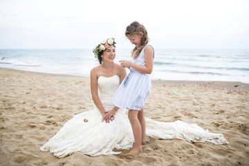 Beautiful bride and sister by the sea