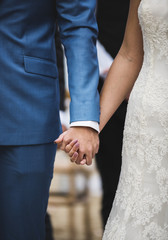 Bride and groom holding hands with love