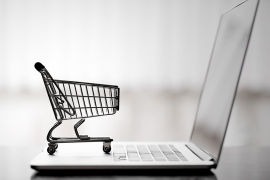 Shopping cart on laptop,online shopping and delivery service concept.