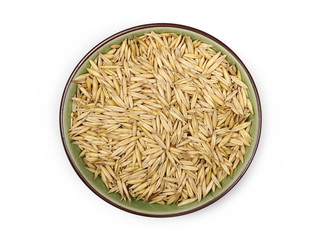Oats in porcelain bowl isolated on white background, top view