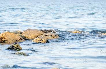 Stones in the sea at the beach in Leptokaria Greece 