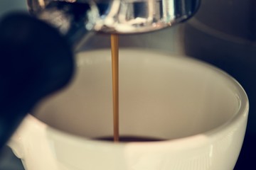 Closeup of coffee machine making espresso drink