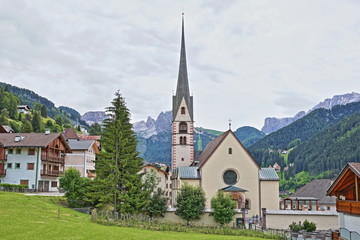 The town of Santa Cristina with the Catholic church in the foreground, Val Gardena, Dolomites, Italy
