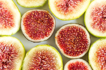Sliced fruits background. Slices of juicy red figs.