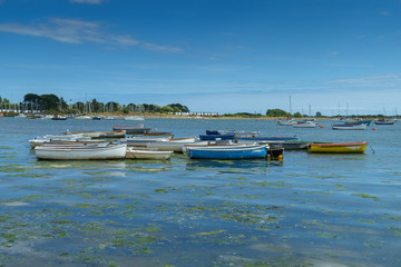 Fototapeta premium Small boats at high tide, Emsworth, Hampshire, UK.