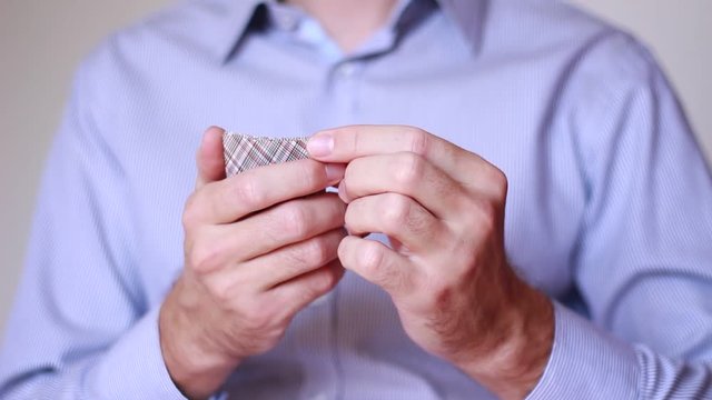 Businessman holding playing cards