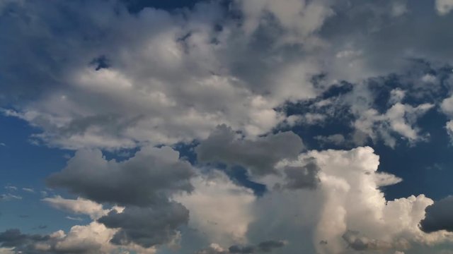 time lapse clip of white fluffy clouds over blue sky
