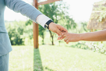 young couple is holding hands