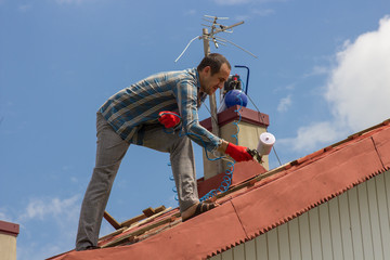 man on the roof of painting
