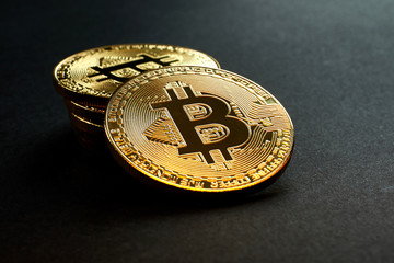 Golden Bitcoins on black background.Virtual money.