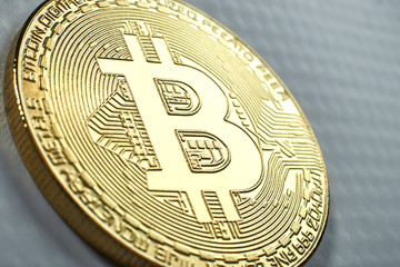 Golden Bitcoin on grey background.Virtual money.