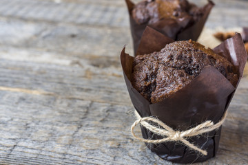 Chocolate muffin on wooden background. Copy space