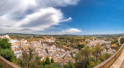 Fototapeta na wymiar Panorama view of Setenil de las Bodegas in Spain, famous for its houses built in caves into rock overhangs above the Rio Trejo