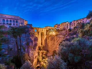 Puente Nuevo bridge and the houses built on the edge of the cliff at night, in the ancient city of Ronda, Spain. © elroce