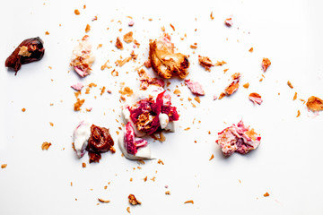 Scattered crumbs of cookies and croissant   isolated on white background. Broken Pastry Macro. Flat lay