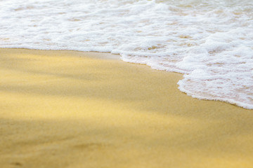 Fototapeta na wymiar Water waves on sand.