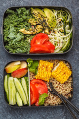 Healthy meal prep containers with quinoa, avocado, corn, zucchini noodles and kale.