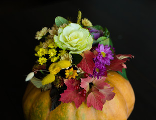 Autumn flowers arrangement in a pumpkin