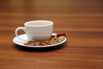 Brewed healthy herbal tea on a wooden background with all dry herbs ingredients. Herbal teas beverage for chinese or thai traditional alternative medicine therapy. 