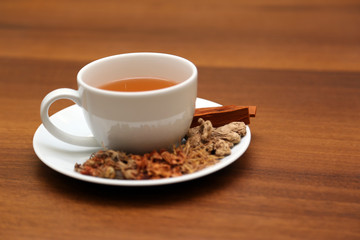 Brewed healthy herbal tea on a wooden background with all dry herbs ingredients. Herbal teas beverage for chinese or thai traditional alternative medicine therapy. 