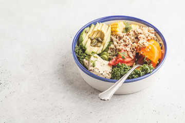 Vegan healthy rainbow salad, buddha bowl with quinoa, tofu, avocado and kale.