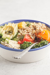 Vegan healthy rainbow salad, buddha bowl with quinoa, tofu, avocado and kale.