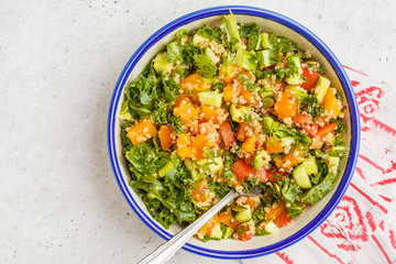 Vegan healthy rainbow salad with quinoa, tofu, avocado and kale.