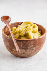 Green vegan banana avocado ice cream in a wooden bowl. Clean eating concept.
