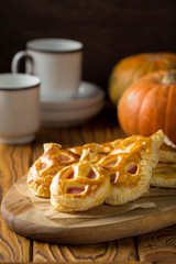 Halloween pumpkin buns with ham and cheese for Breakfast for kids. Dark wooden background
