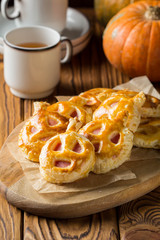 Halloween pumpkin buns with ham and cheese for Breakfast for kids. Dark wooden background