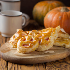 Halloween pumpkin buns with ham and cheese for Breakfast for kids. Dark wooden background