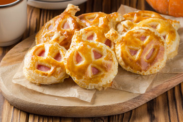 Halloween pumpkin buns with ham and cheese for Breakfast for kids. Dark wooden background